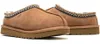 A pair of brown UGG slippers shown from a side-angle on a white background. Voir les images du produit