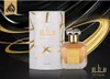 A perfume bottle and its packaging are displayed against a black and gold abstract background. Anteprima dell’immagine prodotto