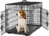 A beagle dog sits inside a black metal dog crate with two doors open. Podgląd zdjęcia produktu