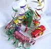 A pile of colorful holographic streamers and party poppers on a white surface. Produktbild-Vorschau