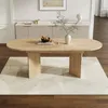 A light wood dining table with a modern design, set on a patterned rug in a well-lit room with a sideboard in the background. Náhľad obrázku produktu