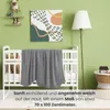 A baby's room with a crib, blanket, and decor. Produktbild-Vorschau