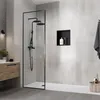 A modern bathroom with a walk-in shower and wooden vanity. Voir les images du produit