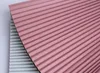 Two pleated fabric samples, one pink and one gray, are shown overlapping. Anteprima dell’immagine prodotto