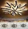 A modern LED ceiling light with a unique, abstract design, shown in different lighting modes. Produktbild-Vorschau