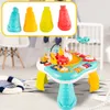 A colorful interactive music table for babies and toddlers, set in a nursery or playroom environment. Produktbild-Vorschau