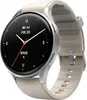 A smartwatch with a silver casing and a beige strap is shown against a white background. Produktbild-Vorschau