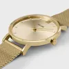 A close-up, angled view of a gold-colored Cluse watch with a mesh band. Voir les images du produit