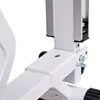 A close-up view of the white metal frame of a piece of exercise equipment, showing a bolt and a pin. Produktbild-Vorschau