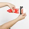 Hands using a tube squeezer to extract contents from a red tube. Produktbild-Vorschau