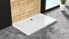 A white shower tray is shown in a modern bathroom setting with grey tiled flooring and wood-effect wall tiles. Produktbild-Vorschau
