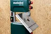 Close-up of a green Metabo BAS 261 bandsaw with a metal table tilted upwards. Anteprima dell’immagine prodotto