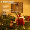 A festive outdoor scene with Christmas decorations and string lights. Produktbild-Vorschau