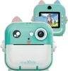 A teal and white instant print camera for kids, designed to look like a cartoon animal, is shown from the front and back. The back view displays a screen showing children playing under a rainbow umbrella. Náhľad obrázku produktu