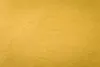 A close-up, textured view of a mustard yellow blanket. Produktbild-Vorschau