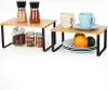 Two small bamboo shelf organizers with black metal legs, each holding various kitchen items. Produktbild-Vorschau