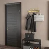 An entryway with a dark wood door, a coat rack with jackets and bags, and a shoe bench. Produktbild-Vorschau