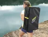 A woman carrying a black bag with yellow accents on her back near a body of water. Produktbild-Vorschau