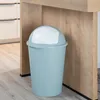 A pastel green trash can with a white lid sits on a light gray floor next to a wooden kitchen island. Produktbild-Vorschau