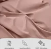 A close-up of pink fabric with icons and text at the bottom indicating product features. Voir les images du produit