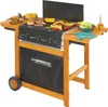 A Campingaz Adelaide 3 Woody DualGas Grill Wagen with food on the grill and side tables. Produktbild-Vorschau