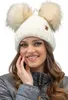 A woman wearing a winter hat with two pom-poms. Produktbild-Vorschau
