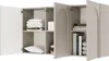 A close-up view of an open gray sideboard with white doors, revealing shelves with folded towels, a pillow, and books. Produktbild-Vorschau