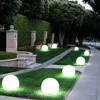A garden path lined with glowing spherical lights at dusk. Náhľad obrázku produktu