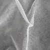 A close-up view of white sheer fabric, likely a curtain, showing its woven texture and folds. Náhľad obrázku produktu