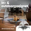 A dog is lying on a raised dog bed in a living room setting. A smaller inset image shows the dog bed with a canopy. Produktbild-Vorschau