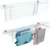 A white drying rack mounted on a balcony railing, with clothes hanging on it. Podgląd zdjęcia produktu