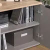 Interior view of a cabinet with shelves, books, and a storage box. Produktbild-Vorschau
