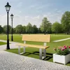 A park scene with a bench, lampposts, and flowers. Produktbild-Vorschau