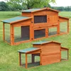Two wooden rabbit hutches with green roofs are shown in a grassy outdoor setting. Produktbild-Vorschau