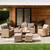 An outdoor patio scene featuring a polyrattan lounge furniture set. Produktbild-Vorschau