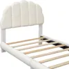 A close-up view of a white upholstered bed frame with a slatted base. Produktbild-Vorschau