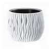 A white planter with a wavy, textured exterior and a black interior, isolated on a white background. Produktbild-Vorschau