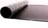 A rolled-up black sheet with a gold geometric pattern is partially unrolled on a white surface. Produktbild-Vorschau