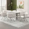 A dining room setting with a white table and chairs, a rug, and wall art. Produktbild-Vorschau