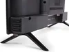 Close-up view of the bottom rear of a black television, showing its stand and ventilation. Produktbild-Vorschau