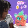A young girl is interacting with a colorful, furry toy robot. The background is a solid purple color with some graphic elements indicating features. Podgląd zdjęcia produktu