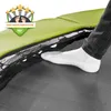 A close-up shot of a person's foot stepping onto a trampoline, highlighting the safety features. Produktbild-Vorschau