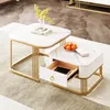 Two nesting coffee tables with marble-look tops and gold metal frames, one with an open drawer. Voir les images du produit