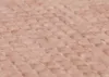 A close-up, textured view of a fabric surface with a diamond-like pattern. Voir les images du produit