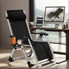 A black zero gravity chair is set up next to a desk with a computer and tablet, suggesting a home office or relaxation space. Produktbild-Vorschau