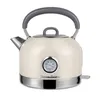 A cream-colored electric kettle with a vintage design, featuring a built-in thermometer and a silver base and spout. Voir les images du produit