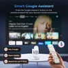 A projector and remote control are shown on a table, with a TV screen displaying movie posters in the background. Text overlays describe Google Assistant features. Produktbild-Vorschau