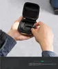 Hands holding a small black case with audio cables inside. Podgląd zdjęcia produktu