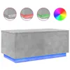 A concrete gray coffee table with blue LED lighting underneath, shown against a white background. Three circular insets show close-ups of the table's edges with different colored lights (white, red, green), and a color wheel graphic is also present. Produktbild-Vorschau
