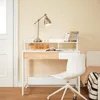 A white desk with a wooden drawer and a white chair in a room with light yellow walls. Podgląd zdjęcia produktu